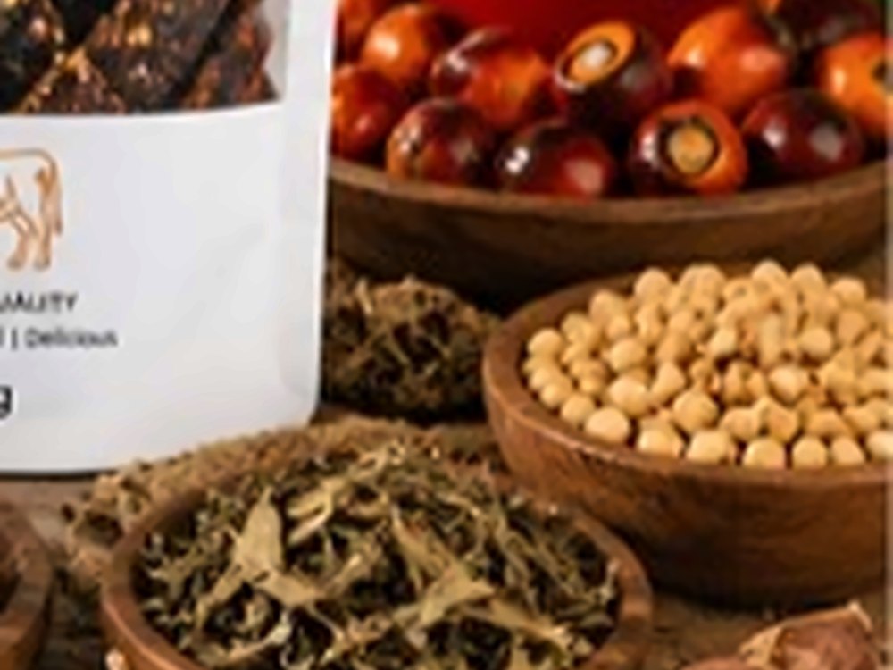 Bowls of melon seed, dried leafy greens and palm fruit on a wooden table